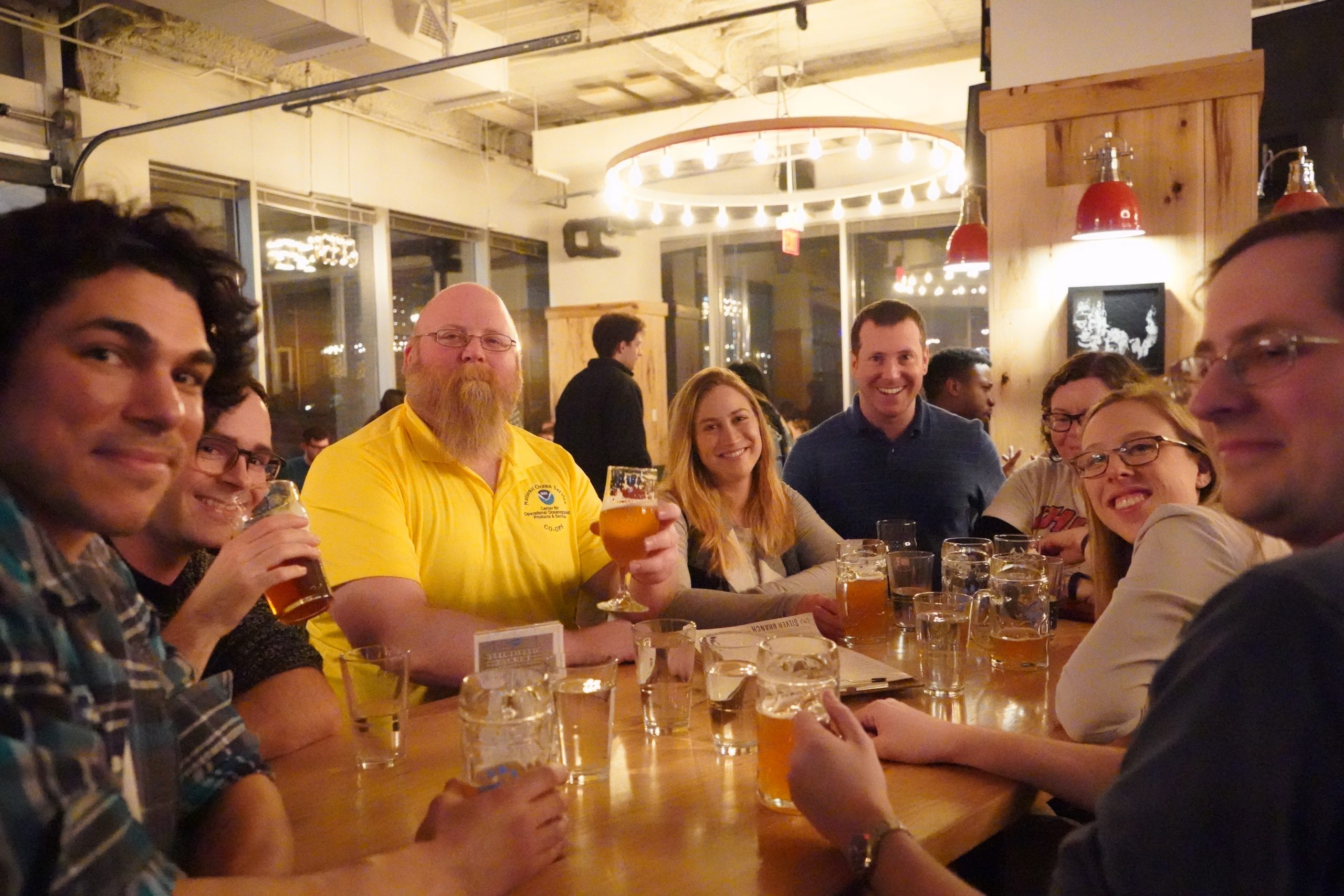 Friends gathered around a table enjoying beer.